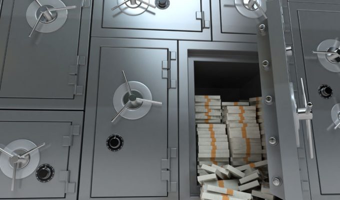 26726383 - 3d rendering of a wall of bank safes one of them open and full of dollars