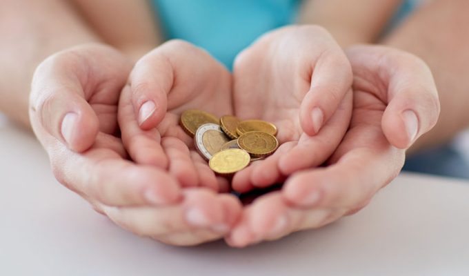 38662893 - family, children, money, investments and people concept - close up of father and daughter hands holding euro money coins